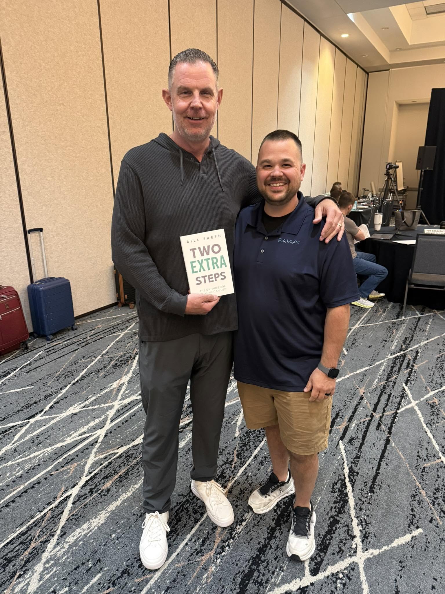 Savvy agent with Bill Faeth and his book Two Extra Steps at an industry event